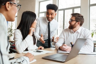 cherful-positive-young-colleagues-using-laptop-computer